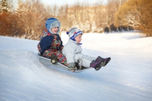 two kids sledding